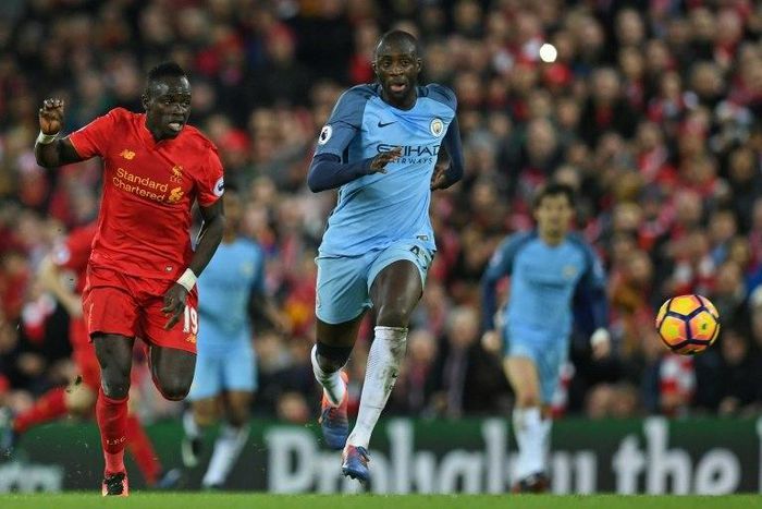 Liverpool's midfielder Sadio Mane (L) vies with Manchester City's midfielder Yaya Toure during the English Premier League football match December 31, 2016