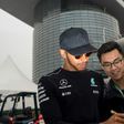 Mercedes' British driver Lewis Hamilton signs an autograph for a Chinese fan in the paddock in Shanghai ahead of the Formula One Chinese Grand Prix