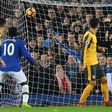 Everton defender Ashley Williams (2R) scores his team's second goal after a disputed corner award