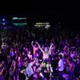 Thousands of partygoers dance on Haad Rin beach during a Full Moon Party on the southern Thai island of Ko Phangan