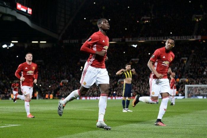 Manchester United's French midfielder Paul Pogba (C) celebrates scoring their first goal from the penalty spot against Fenerbahce at Old Trafford in Manchester, north west England, on October 20, 2016