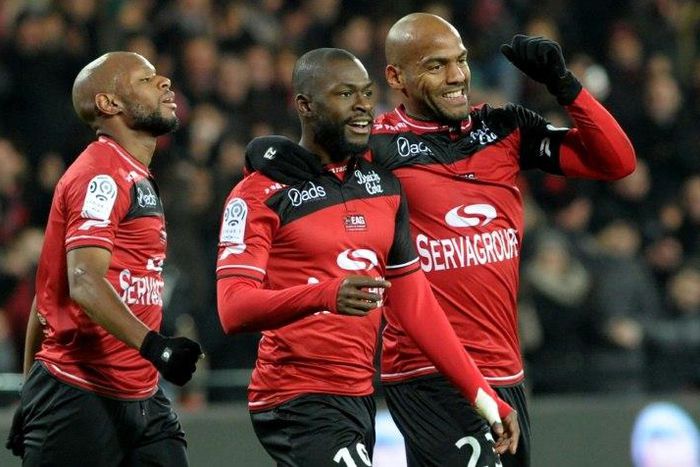 Guingamp's forward Yannis Salibur (C) is congratulated by forward Jimmy Briand (R) after scoring during the French Ligue 1 football match against Nantes on December 3, 2016