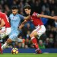 Manchester City's Sergio Aguero (C) tries to find a gap between Middlesbrough's Ben Gibson (L) and George Friend