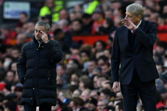 Manchester United's manager Jose Mourinho and Arsenal's manager Arsene Wenger watch their players from the touchline during the match on November 19, 2016