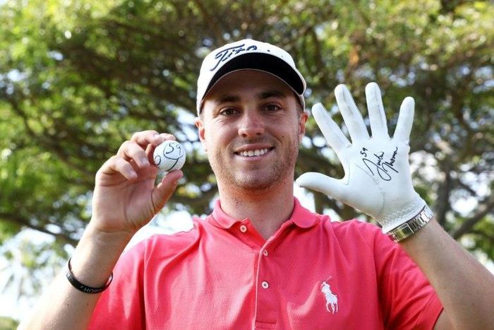Justin Thomas of the United States celebrates after scoring a 59 during the first round of the Sony Open In Hawaii at Waialae Country Club on January 12, 2017 in Honolulu, Hawaii