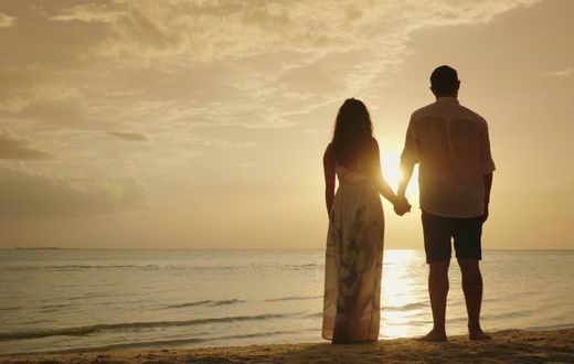 Stock photo of a couple's silhouette on a beach [Credit - Shutterstock]