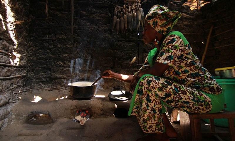 African woman in a hut