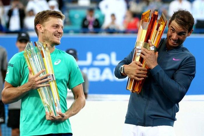 Spain's Rafael Nadal (R) poses with the winner's trophy with Belgium's David Goffin after the final of the Mubadala World Tennis Championship 2016 in Abu Dhabi on December 31, 2016. Nadal won 6-4, 7-6.