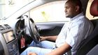 An Uber taxi driver sits in his car in Nairobi March 9, 2016.    REUTERS/Noor Khamis