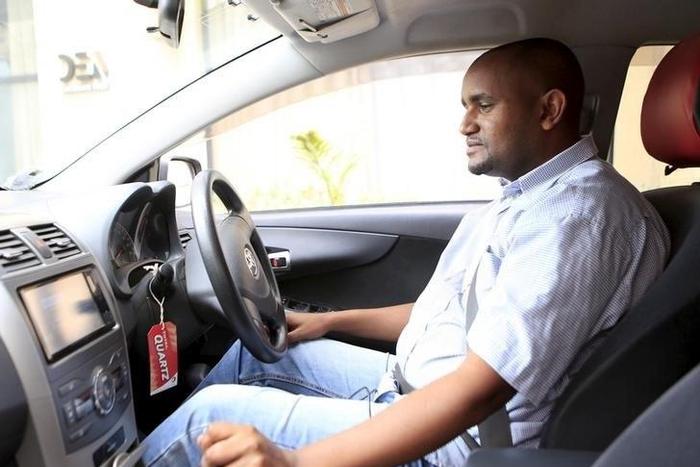 An Uber taxi driver sits in his car in Nairobi March 9, 2016.    REUTERS/Noor Khamis