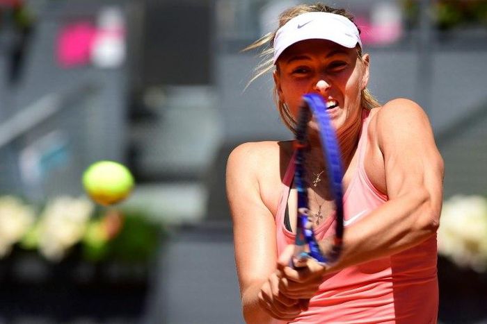 Russian tennis player Maria Sharapova returns a ball to French tennis player Caroline Garcia during the Madrid Open tournament at the Caja Magica (Magic Box) sports complex in Madrid on May 6, 2015