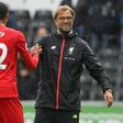 Liverpool manager Jurgen Klopp (right) shakes hands with defender Joel Matip at the Liberty Stadium in Swansea, south Wales, on October 1, 2016