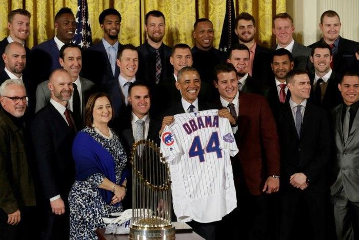 US President Barack Obama poses with a jersey as he welcomes the World Champion Chicago Cubs baseball team to the White House on January 16, 2017