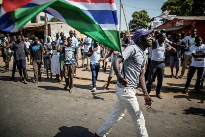 A man waves a Gambian flag while he celebrates the victory of Gambia's opposition candidate Adama Barrow during the Presidential Elections on December 2, 2016, in Serekunda, Banjul