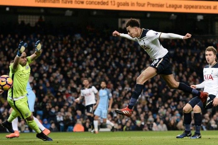 Tottenham Hotspur's midfielder Dele Alli (2nd R) jumps to head their first goal past Manchester City's goalkeeper Claudio Bravo on January 21, 2017
