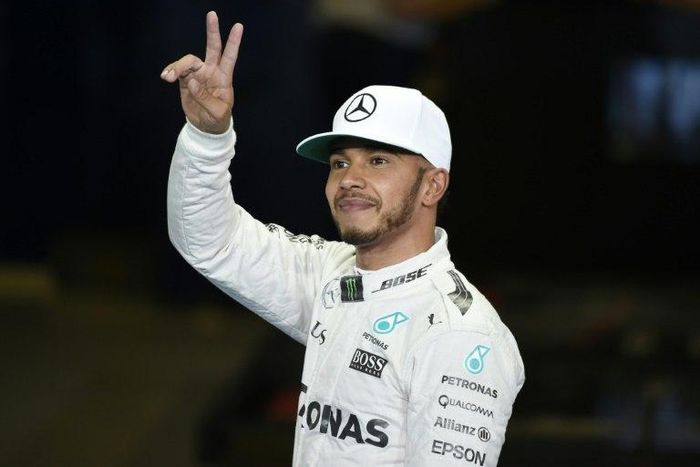 The Mercedes F1 Team's British driver Lewis Hamilton gestures after taking pole in qualifying session as part of the Abu Dhabi Formula One Grand Prix at the Yas Marina circuit on November 26, 2016