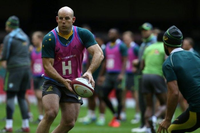Australia's hooker Stephen Moore passes the ball as Australian players train at the Principality stadium in Cardiff on November 4, 2016 on the eve of their international match against Wales