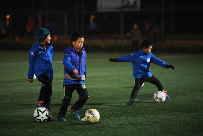 Boys attend a training session at a football club in Beijing