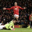 Manchester United's Zlatan Ibrahimovic lifts the ball over Sunderland's goalkeeper Jordan Pickford to score the team's second goal during the match at Old Trafford on December 26, 2016