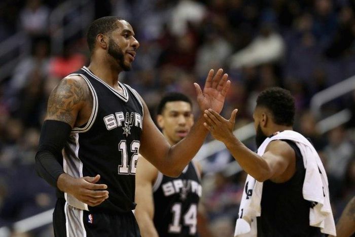 LaMarcus Aldridge of the San Antonio Spurs celebrates during a timeout against the Washington Wizards at Verizon Center on November 26, 2016