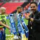 Huddersfield Town's head coach David Wagner gestures as he holds the Championship Playoff trophy on the pitch after winning the penalty shoot-out in the English Championship play-off final football match against and Reading
