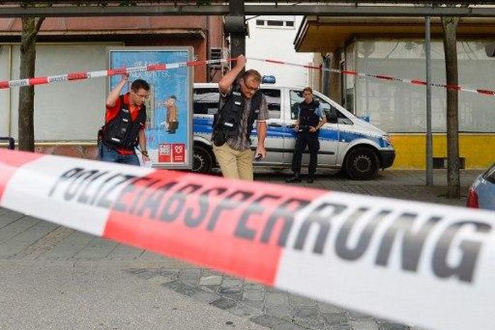 Police officers investigate the site of an attack
