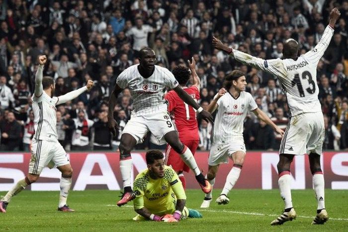 Besiktas' Vincent Aboubakar (C) celebrates after scoring against Benfica Lisbon at the Vodafone arena - both teams join Napoli in a race to stay in the Champions League
