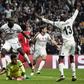 Besiktas' Vincent Aboubakar (C) celebrates after scoring against Benfica Lisbon at the Vodafone arena - both teams join Napoli in a race to stay in the Champions League
