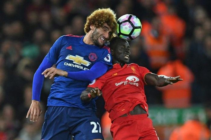 Manchester United's Marouane Fellaini (left) battles with Liverpool's Sadio Mane at Anfield on October 17, 2016