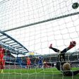 Leicester City's goalkeeper Kasper Schmeichel falls after failing to stop a goal by Chelsea's Diego Costa during their English Premier League match, at Stamford Bridge in London, on October 15, 2016