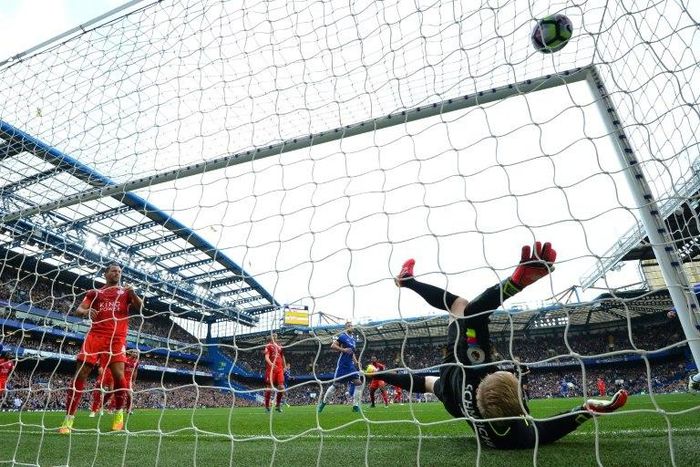 Leicester City's goalkeeper Kasper Schmeichel falls after failing to stop a goal by Chelsea's Diego Costa during their English Premier League match, at Stamford Bridge in London, on October 15, 2016
