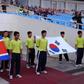 Flags of North Korea (L) and South Korea are carried prior to a football match between the two countries' U-23 teams during the Vietnam Football (VFF) Federation Son Ha Cup tournament on November 4, 2010