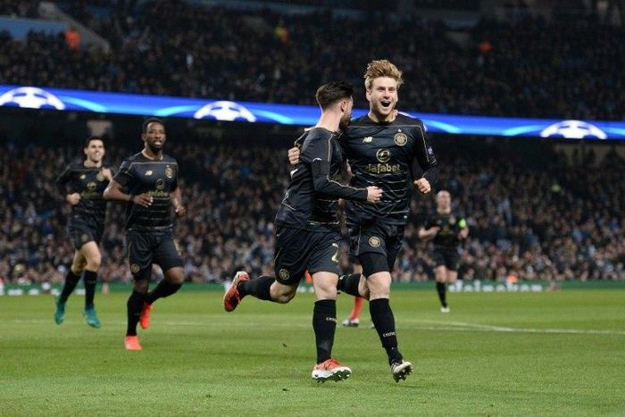 Celtic's Patrick Roberts (C) celebrates scoring a goal with teammate Stuart Armstrong during a UEFA Champions League match in Manchester, on December 6, 2016