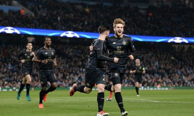 Celtic's Patrick Roberts (C) celebrates scoring a goal with teammate Stuart Armstrong during a UEFA Champions League match in Manchester, on December 6, 2016