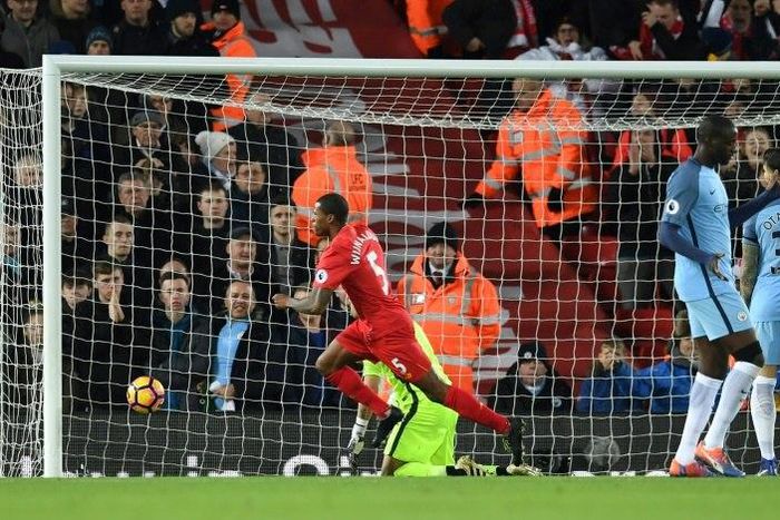 Liverpool's Dutch midfielder Georginio Wijnaldum (C) celebrates after scoring the opening goal of the English Premier League football match between Liverpool and Manchester City at Anfield in Liverpool, north west England on December 31, 2016