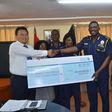 The IGP receiving a dummy cheque from a representative of the association