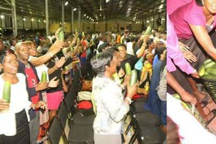 Congregation buy anointed cucumber during church service.