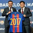 Barcelona's president Josep Maria Bartomeu (left) and CEO of Japanese company Rakuten Hiroshi Mikitani display the new team jersey after signing an agreement in Barcelona on November 16, 2016