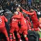 Lyon's players celebrate their victory at the end of the UEFA Europa League second leg quarter final football match against Besiktas April 20, 2017