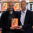 Manchester City's manager Pep Guardiola (L) poses for a photograph with former Dutch football player and manager Jordi Cruyff at an event to promote Johan Cruyff's autobiography "My Turn" in central London on October 6, 2016