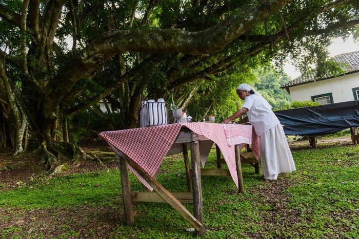 A 'slave' getting the table ready for guests