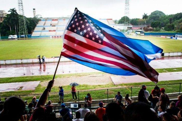 Fans wave Cuban and US flags on June 2, 2015, during the friendly game in Havana between the New York Cosmos and Cuba