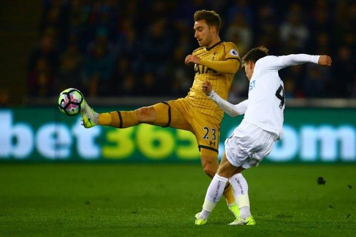 Tottenham Hotspur's midfielder Christian Eriksen (L) vies with Swansea City's English midfielder Tom Carroll during the English Premier League football match between Swansea City and Tottenham Hotspur at The Liberty Stadium on April 5, 2017