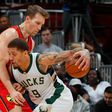 Michael Beasley (R) of the Milwaukee Bucks drives against Mike Dunleavy of the Atlanta Hawks during their NBA game at Philips Arena in Atlanta, Georgia, on January 15, 2017