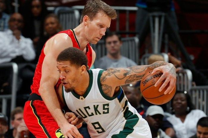 Michael Beasley (R) of the Milwaukee Bucks drives against Mike Dunleavy of the Atlanta Hawks during their NBA game at Philips Arena in Atlanta, Georgia, on January 15, 2017