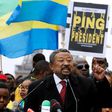 Gabonese opposition leader Jean Ping (C), surrounded by supporters waving Gabonese flags, gestures as he speaks on the Human Rights Esplanade