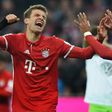 Bayern Munich's Thomas Mueller (L) and Thiago Alcantara (R) celebrate after the third goal for Munich against Wolfsburg on December 10, 2016
