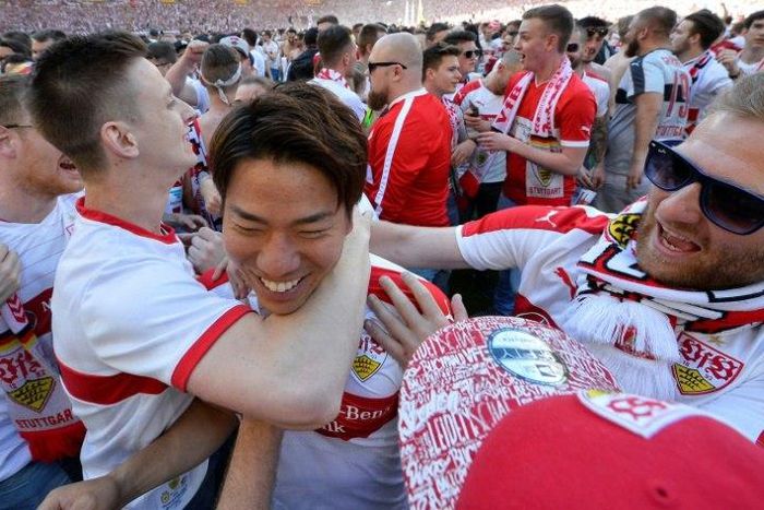 VfB Stuttgart's forward Takuma Asano (C) is celebrated by fans after the German second division team was promoted to the Bundesliga on May 21, 2017