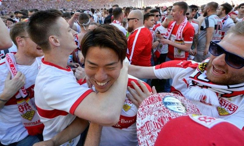VfB Stuttgart's forward Takuma Asano (C) is celebrated by fans after the German second division team was promoted to the Bundesliga on May 21, 2017