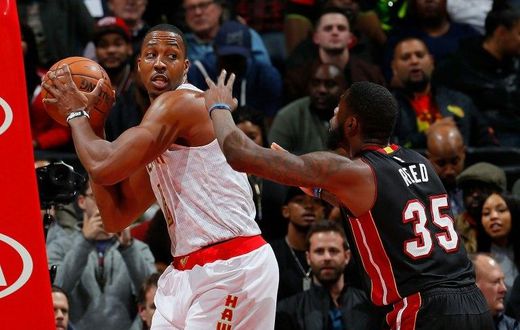 Dwight Howard of the Atlanta Hawks grabs a rebound against Willie Reed of the Miami Heat at Philips Arena on December 7, 2016